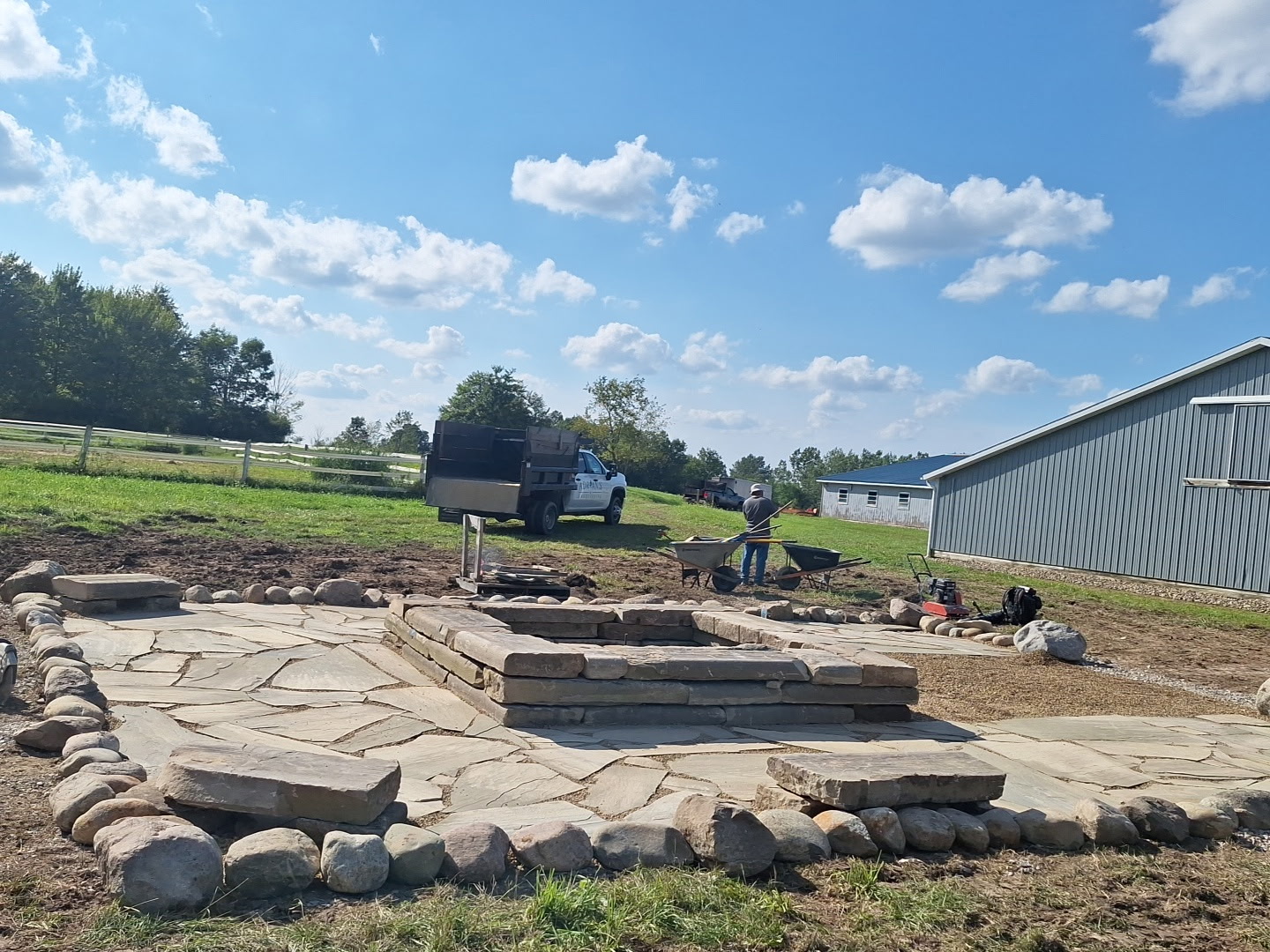 A closer look at the natural stone patio and circular fire-pit project during construction.