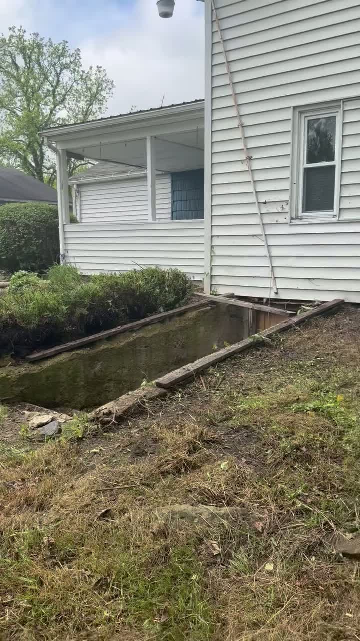 An on-site walkthrough of the existing beds and outdoor areas around a property before further work.